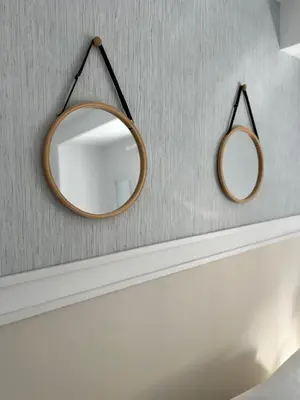 a bathroom with two mirrors hanging on a wall at Victoria Centro 34 in Puerto Real