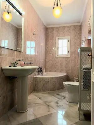 a bathroom with a sink and a tub and a toilet at Casa de los Patios in Sanlúcar de Barrameda