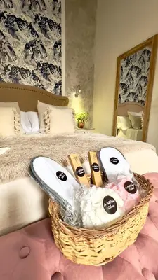 a basket of shoes sitting on top of a bed at Wehostcostaluz Le Petit Palace Catedral con parking gratuito in Jerez de la Frontera