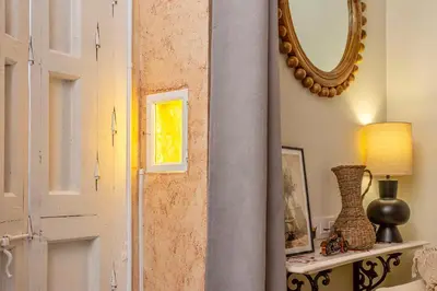 a door in a room with a mirror at Wehostcostaluz Le Petit Palace Catedral con parking gratuito in Jerez de la Frontera