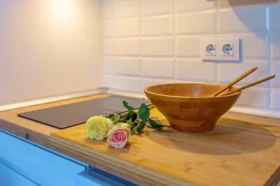 a bowl on a counter with flowers on a cutting board at Wehostcostaluz Le Petit Palace Catedral con parking gratuito in Jerez de la Frontera