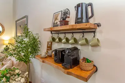 a shelf with coffee mugs on a wall at Wehostcostaluz Le Petit Palace Catedral con parking gratuito in Jerez de la Frontera