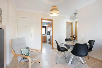 a kitchen and dining room with a table and chairs at Golden Sands Apartment - Chiclana de la frontera in Novo Sancti Petri