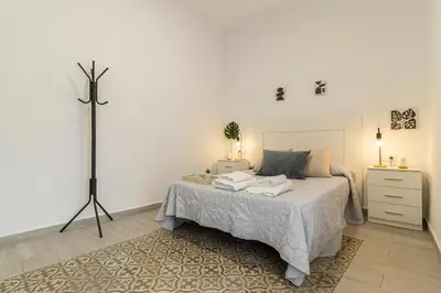 a bedroom with a bed with two towels on it at Apartamento Santa Clara 1 in Jerez de la Frontera