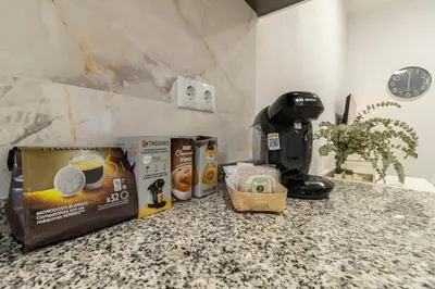 a counter top with a coffee maker and a box of coffee at Apartamento Santa Clara 1 in Jerez de la Frontera