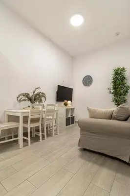 a living room with a table and a couch at Apartamento Santa Clara 1 in Jerez de la Frontera
