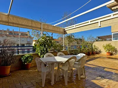 a patio with a white table and chairs at Apartamento Albatros - Ole Solutions in Sanlúcar de Barrameda