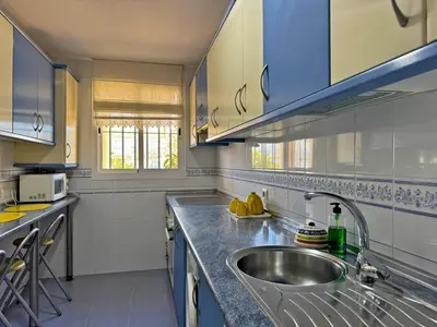 a kitchen with a sink and a counter top at Apartamento Albatros - Ole Solutions in Sanlúcar de Barrameda