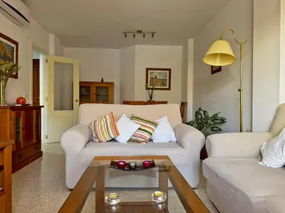 a living room with a couch and a table at Apartamento Albatros - Ole Solutions in Sanlúcar de Barrameda