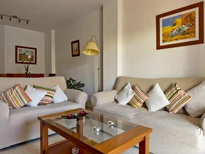 a living room with two couches and a coffee table at Apartamento Albatros - Ole Solutions in Sanlúcar de Barrameda