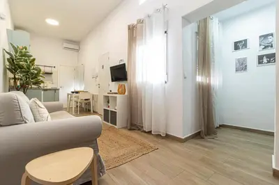 a living room with a couch and a table at Apartamento Santa Clara 3 in Jerez de la Frontera