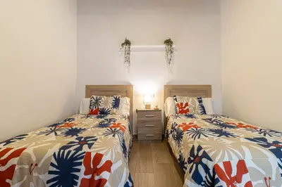 two beds sitting next to each other in a bedroom at Apartamento Santa Clara 3 in Jerez de la Frontera