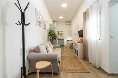 a living room with a couch and a table at Apartamento Santa Clara 3 in Jerez de la Frontera
