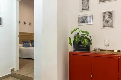a living room with a red cabinet with a plant on it at Apartamento Santa Clara 3 in Jerez de la Frontera