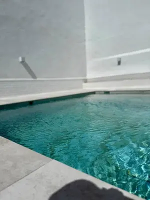 a swimming pool with blue water in a building at Villa Palacio con Piscina Privada in Puerto Real