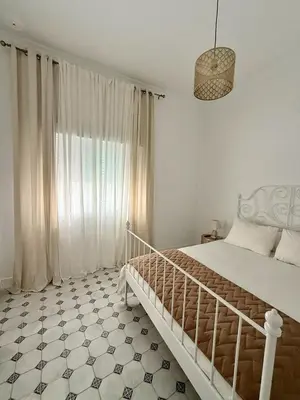 a bedroom with a bed and a large window at Villa Palacio con Piscina Privada in Puerto Real
