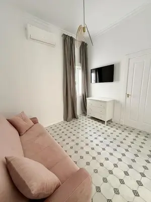a living room with a couch and a tv at Villa Palacio con Piscina Privada in Puerto Real