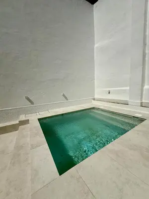 a swimming pool in a white room with water in the floor at Villa Palacio con Piscina Privada in Puerto Real