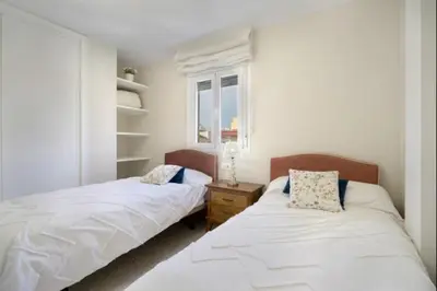 a bedroom with two beds and a window at Agua Marina by Staycare in Rota