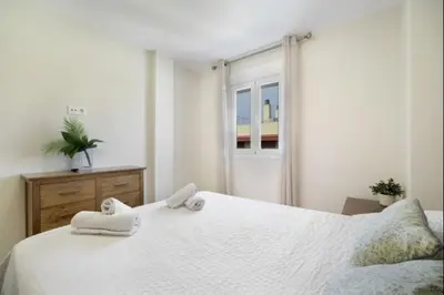 a bedroom with a white bed and a window at Agua Marina by Staycare in Rota