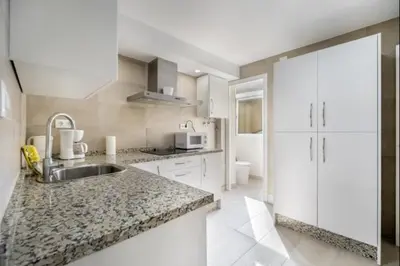 a kitchen with a sink and a counter top at Agua Marina by Staycare in Rota