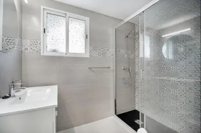 a white bathroom with a shower and a sink at Agua Marina by Staycare in Rota