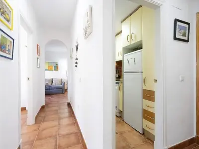 a hallway with a kitchen and a living room at Arrecife Home by Staycare in Rota