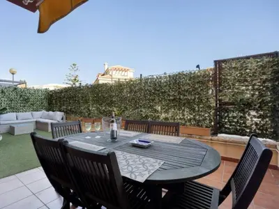 a black table with chairs and a bottle of wine at Arrecife Home by Staycare in Rota