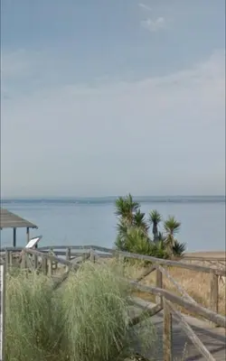 a beach with a wooden fence and the ocean at Arrecife Home by Staycare in Rota