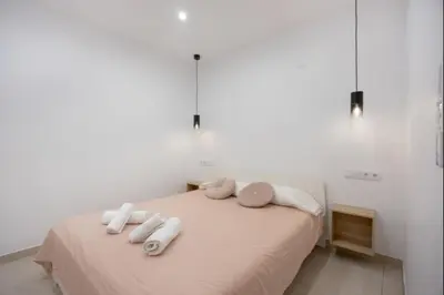 a bedroom with a bed with towels on it at Atico castelar by Staycare in Rota