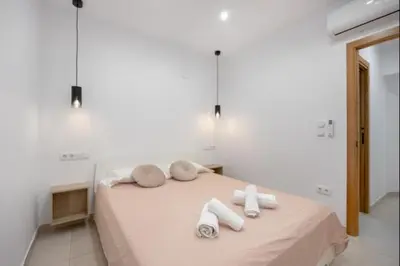 a bedroom with a bed with towels on it at Atico castelar by Staycare in Rota