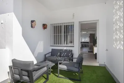 a living room with a couch and a table and chairs at Atico castelar by Staycare in Rota