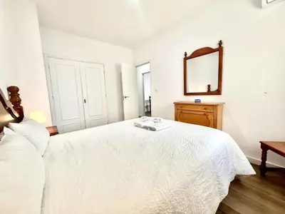 a bedroom with a white bed and a mirror at Brisa marina free parking by Staycare in Rota