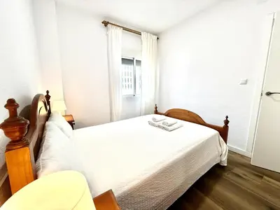 a bedroom with a bed and a window at Brisa marina free parking by Staycare in Rota