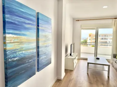 a living room with a large painting on the wall at Brisa marina free parking by Staycare in Rota