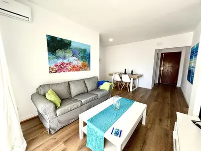 a living room with a couch and a table at Brisa marina free parking by Staycare in Rota