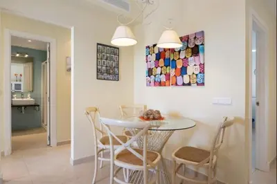 a kitchen and dining room with a table and chairs at Budha Candor free parking by Staycare in Rota