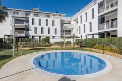 a large swimming pool in front of a building at Budha Candor free parking by Staycare in Rota