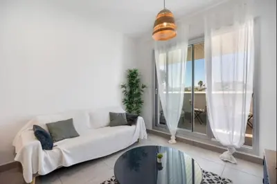 a living room with a white couch and a glass table at Dunas Candor free parking by Staycare in Rota