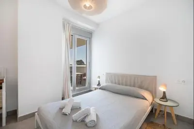 a bedroom with a bed with two towels on it at Dunas Candor free parking by Staycare in Rota