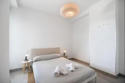 a bedroom with a bed with towels on it at Dunas Candor free parking by Staycare in Rota