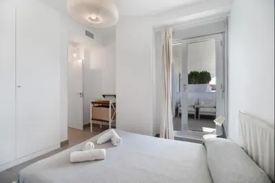 a bedroom with a bed with two towels on it at Dunas Candor free parking by Staycare in Rota