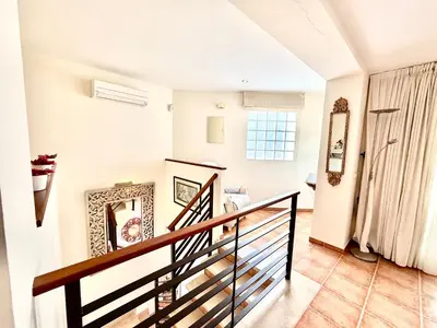 a staircase in a home with white walls at V Centenario free parking by Staycare in Rota