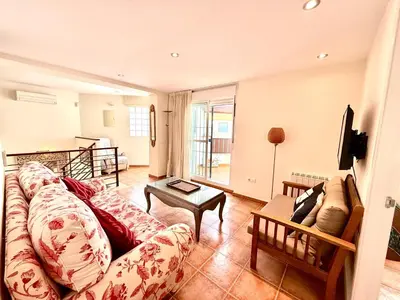 a living room with a couch and a table at V Centenario free parking by Staycare in Rota