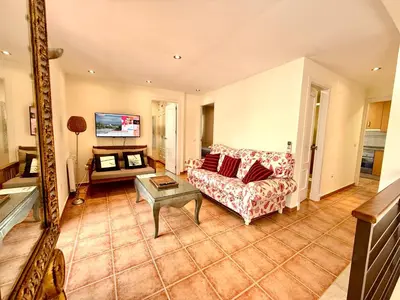 a living room with a couch and a table at V Centenario free parking by Staycare in Rota