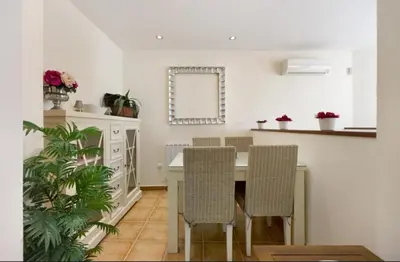 a kitchen with a table and chairs and a mirror at V Centenario free parking by Staycare in Rota