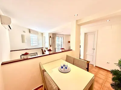 a dining room with a table and chairs at V Centenario free parking by Staycare in Rota