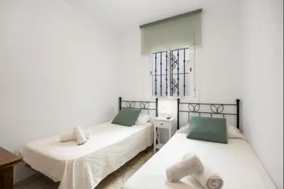 a bedroom with two beds and a window at Girasoles Rota by Staycare in Rota