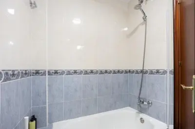 a bathroom with a bath tub and a shower at Girasoles Rota by Staycare in Rota