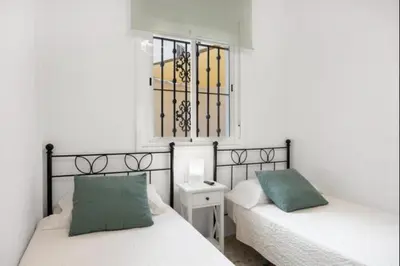 a bedroom with two beds and a window at Girasoles Rota by Staycare in Rota